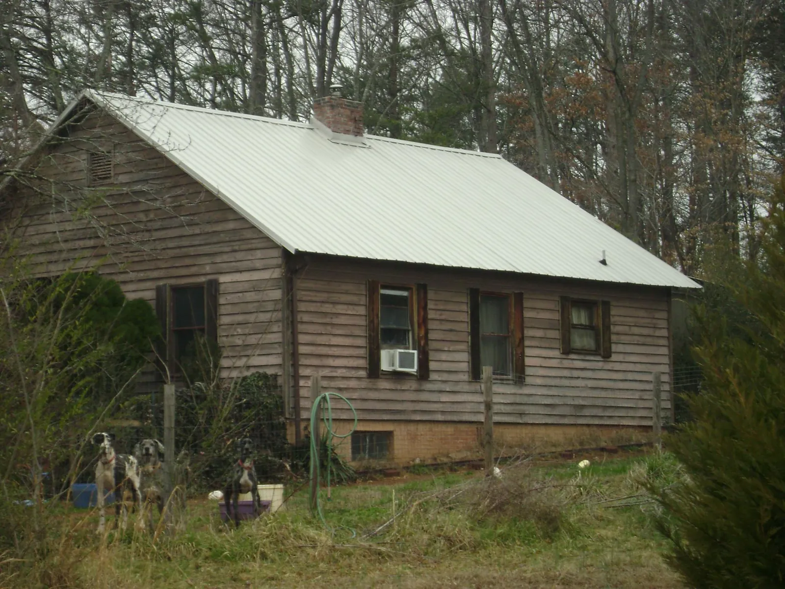 White metal roof on an old wood sided farmhouse, from a Metal Roof Installation job in Sperryville